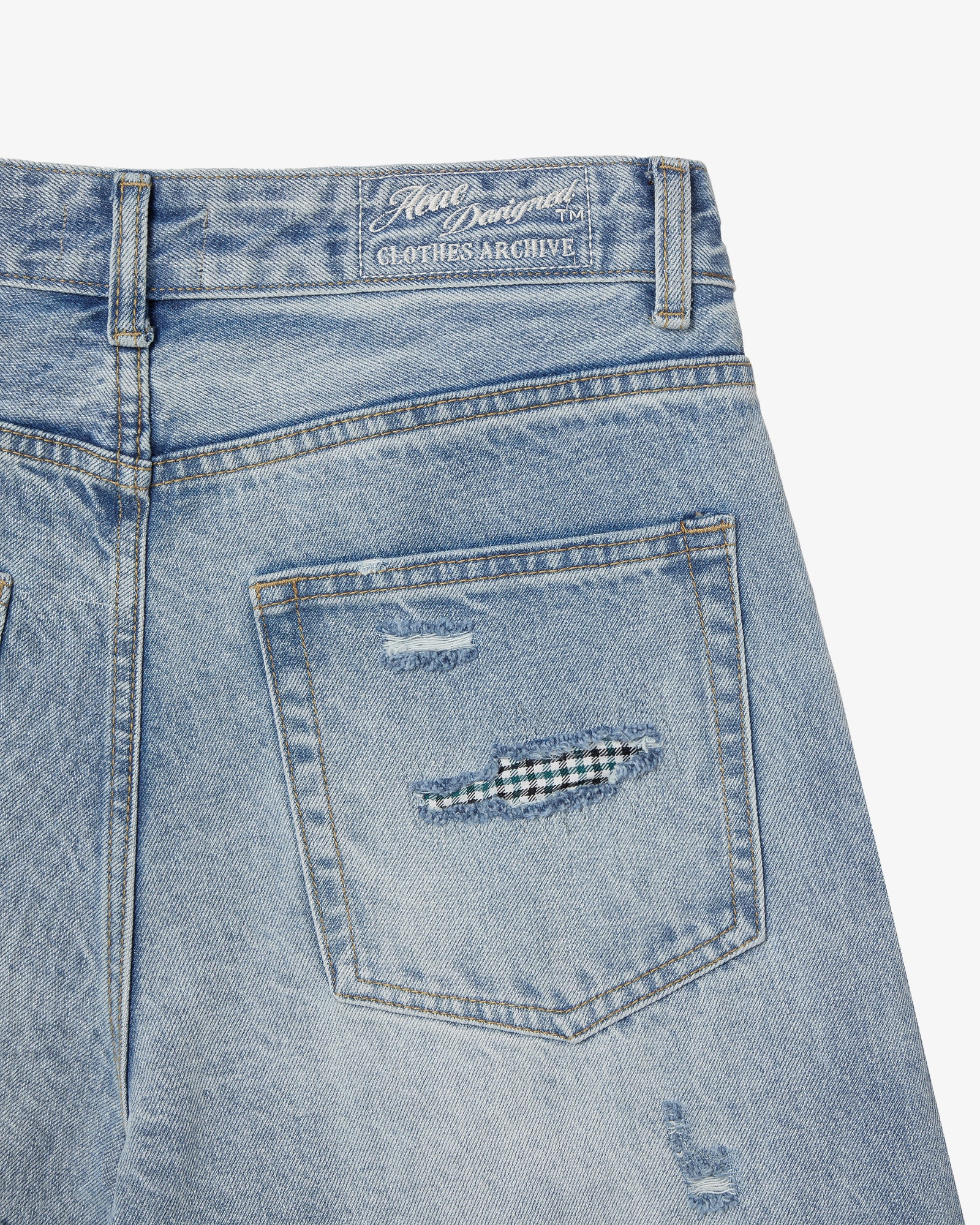 The back side pocket of a pair of light blue denim jeans from Korean brand aeae, for sale at Shim House