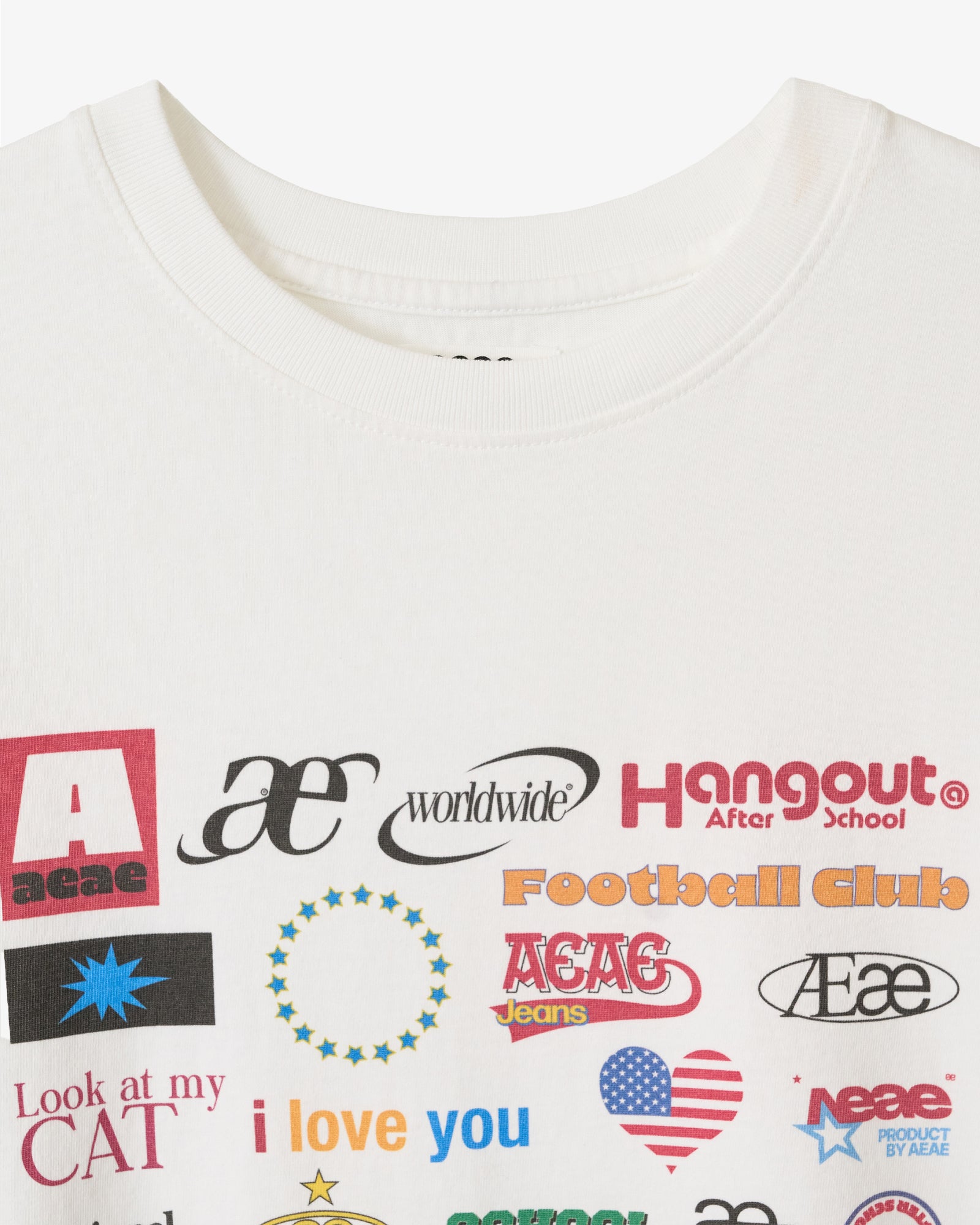 A close up on the neckline of a white t-shirt from Korean brand aeae with a colorful sticker style print on the front, for sale at Shim House