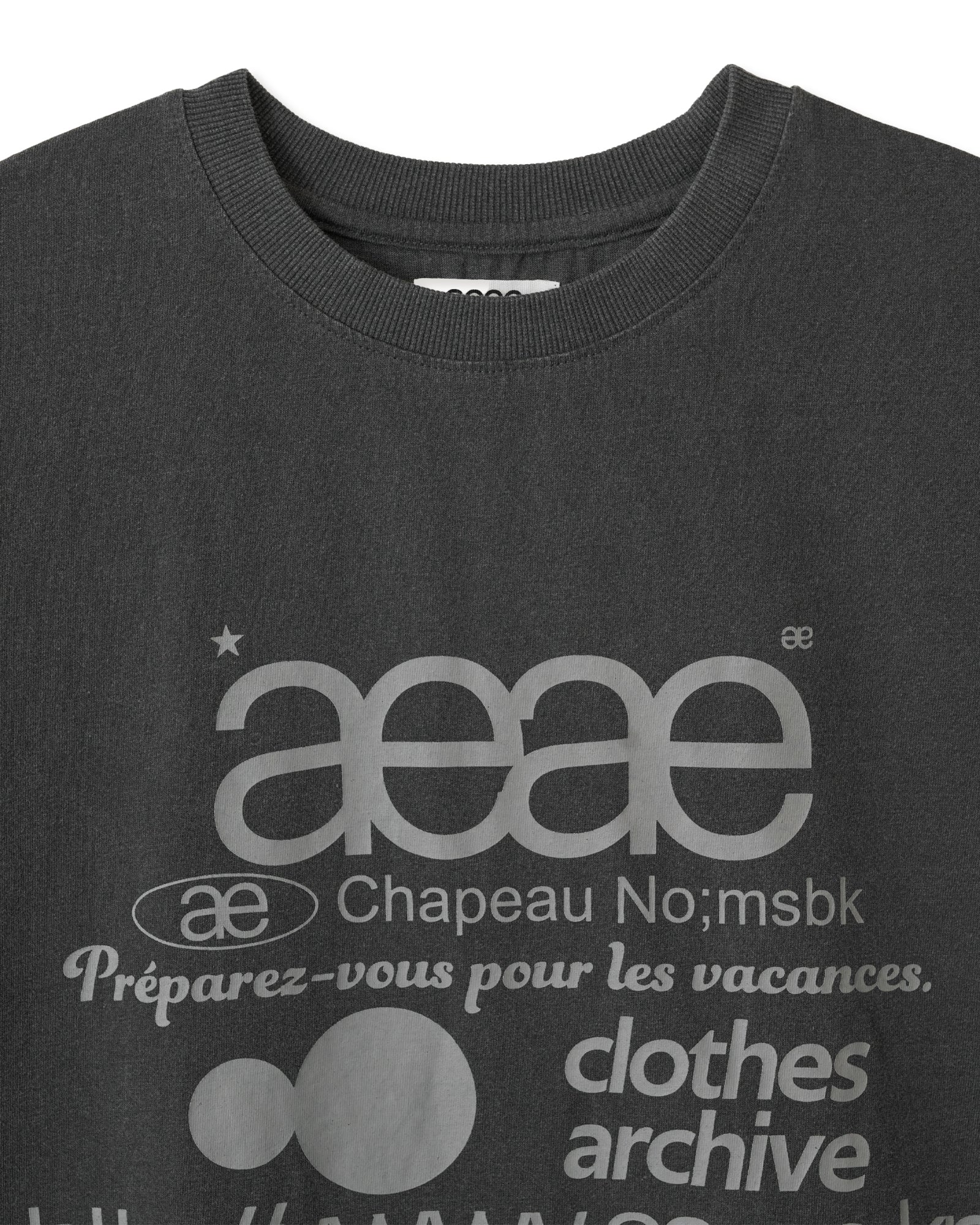A Close up image on neckline of pigment black short sleeve t-shirt from Korean brand aeae with signature web logo design print in a light grey colour, for sale at Shim House