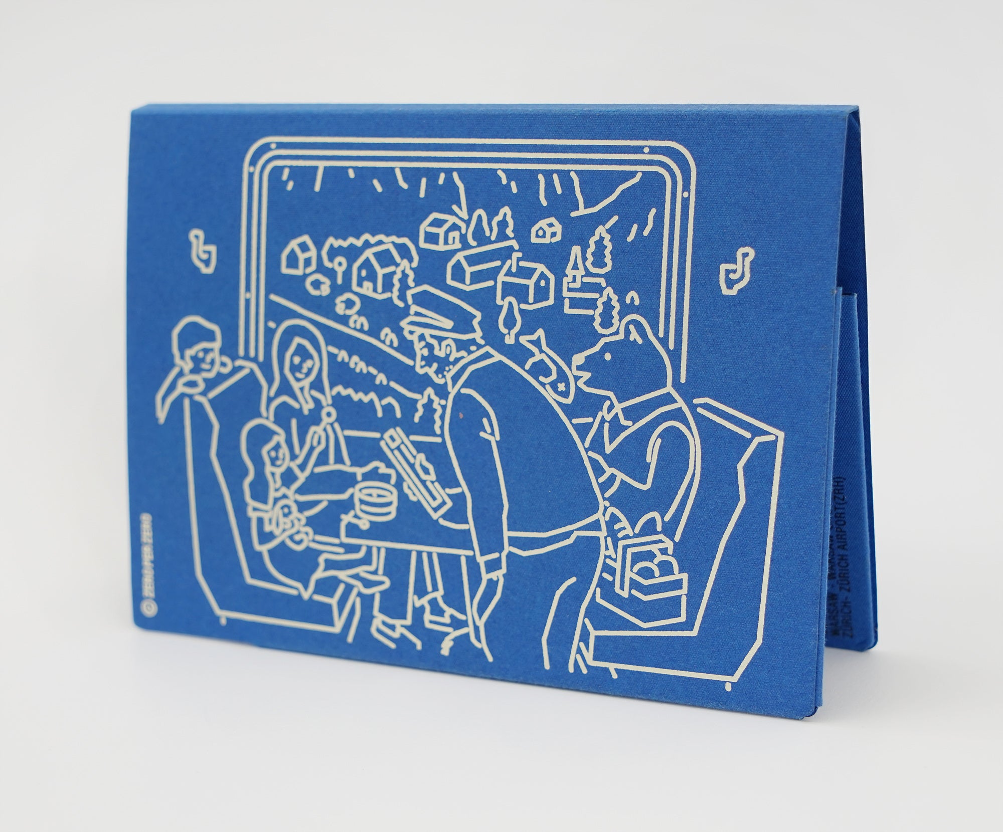 The back of a blue paper passport cover that has a drawing of people on a train, created by Korean brand Zero Per Zero and for sale at Shim House