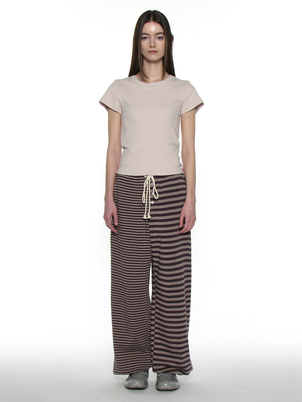 173cm tall woman wearing striped trackpants facing front on
