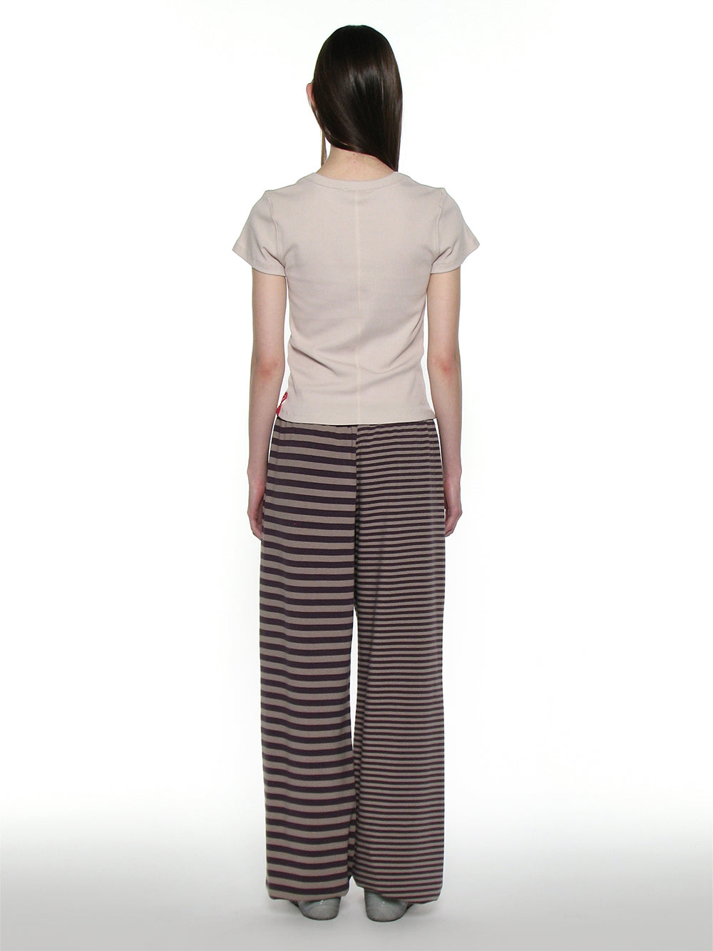 173cm tall woman facing the back wearing striped trackpants