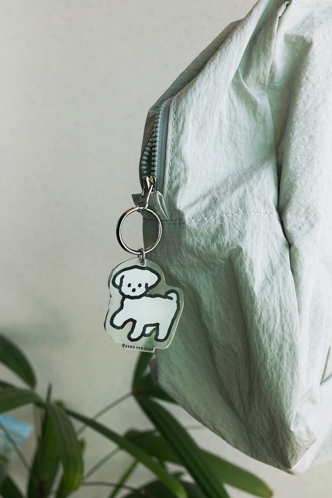 A white dog drawing keyring created by a Korean brand called Zero Per Zero and for sale at Shim House