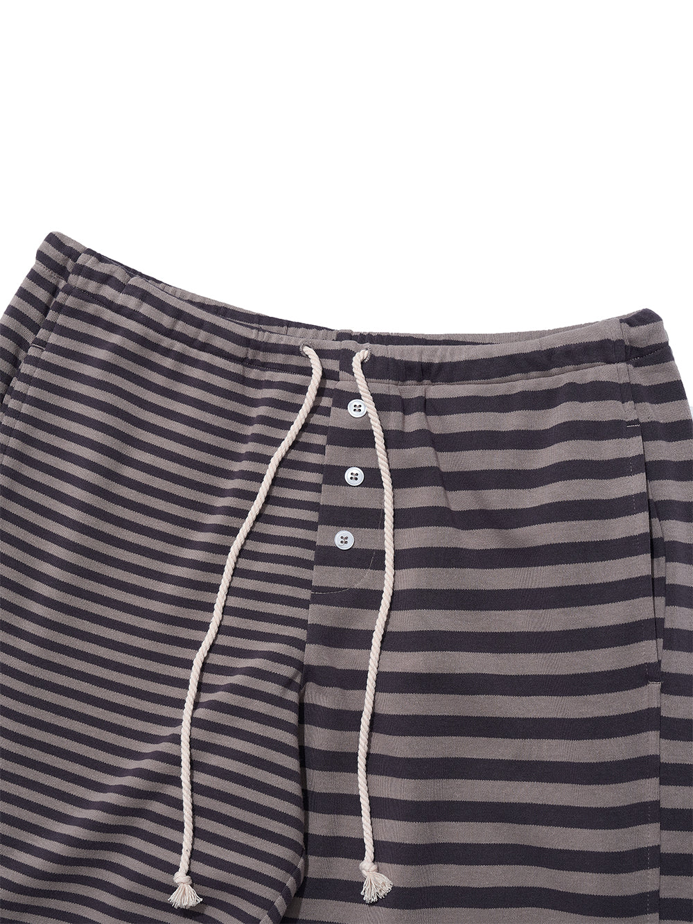 Close up of the waist of striped trackpants with adjustable rope waist